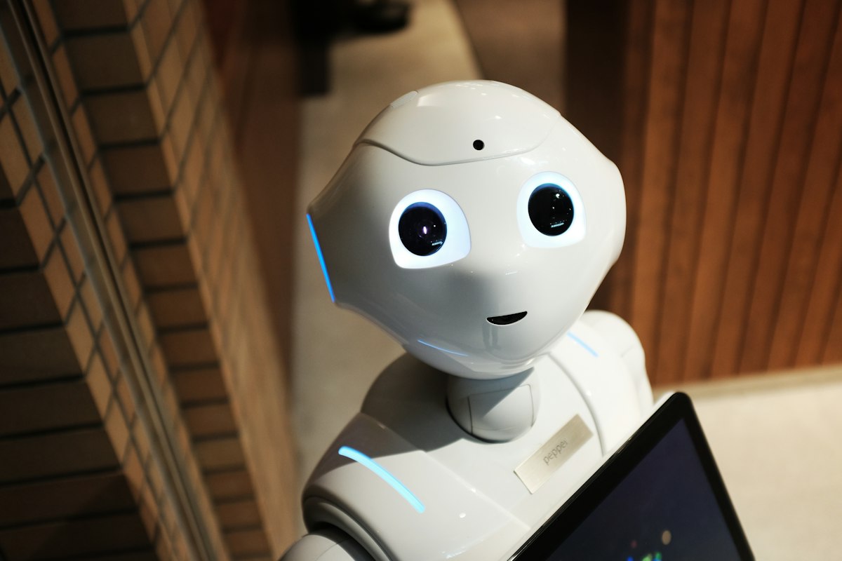 A white humanoid robot — generic stock photo representing modern humanoid robotics, not the actual Feather robot from Feather Robotics