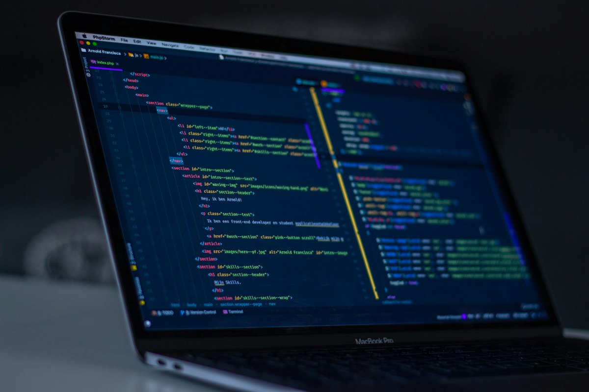 A dark code-editor screen filled with colorful programming source code — generic developer stock photo illustrating the Claude Code vs Codex comparison below, not the official Terminal-Bench 4.0 leaderboard