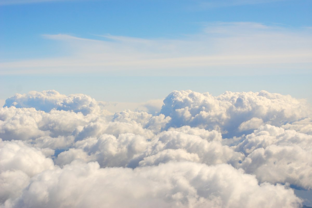 Vast blue cloudscape under daylight — generic stock photo representing the Cloudflare acquires Deno announcement and the edge-network angle of the story, not an actual Cloudflare or Deno logo, product graphic, or deal illustration