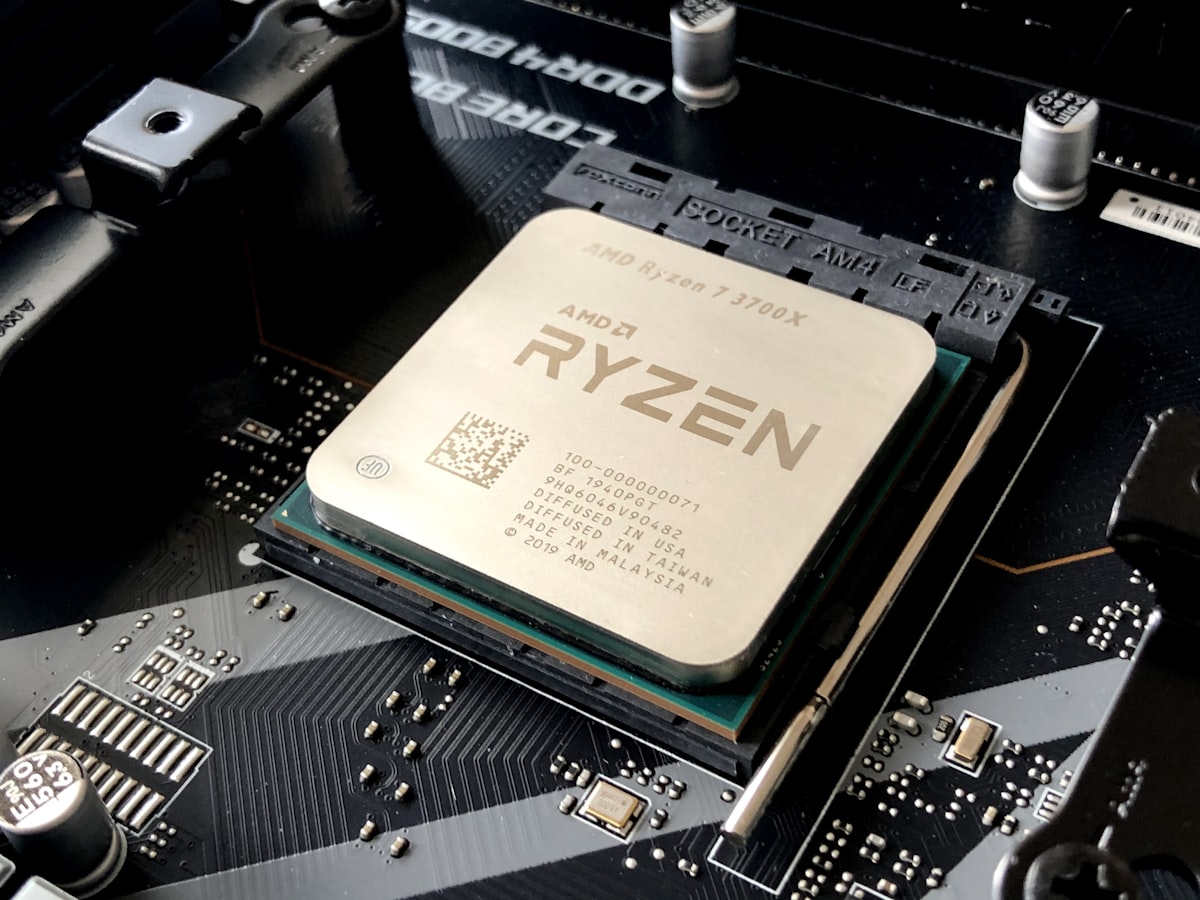 Generic stock photo of a close-up macro shot of a computer processor being mounted on a motherboard — a conceptual illustration of custom ASIC design and packaging, not an actual MediaTek chip