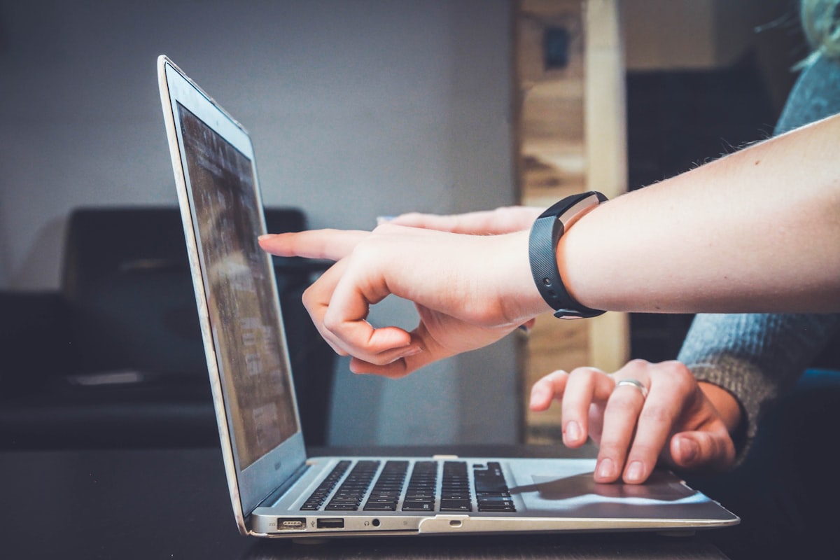 A person gesturing at a laptop screen — a generic stock photo, not an actual technical diagram