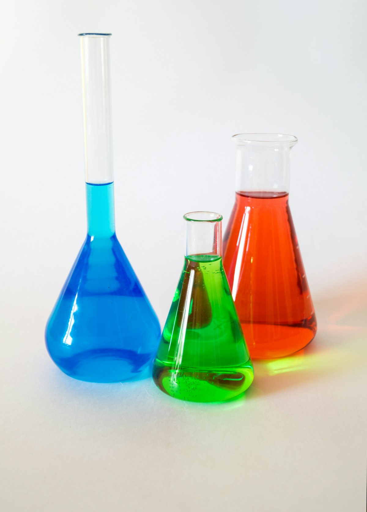 Fluid in motion in laboratory flasks — a generic stock photo illustrating real-world fluid flow of the kind the Navier–Stokes equations describe