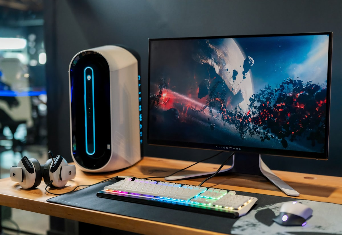 Ryzen AI Halo Project Zenith hardware — generic stock photo of a compact desktop PC tower with monitor and RGB keyboard on a desk, illustrative of Zenith-class hardware rather than the actual Lenovo ThinkCentre X Ultra or AMD Ryzen AI Halo