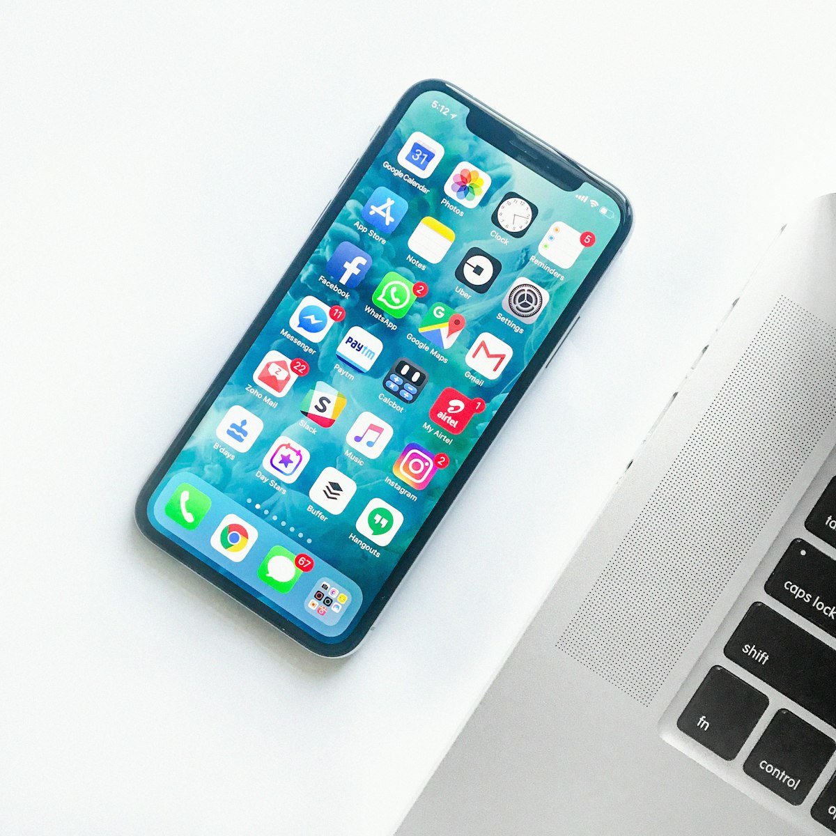 Generic stock photo of a hand holding a smartphone — used to illustrate the Siri AI launch and Apple Intelligence, not a screenshot of the Siri UI or any actual Apple product or feature