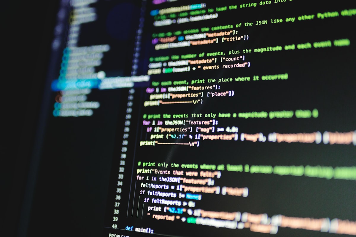 A close-up of unrelated Python source code on screen — a generic developer stock photo, not an actual benchmark bar chart. See the tables below for real benchmark figures